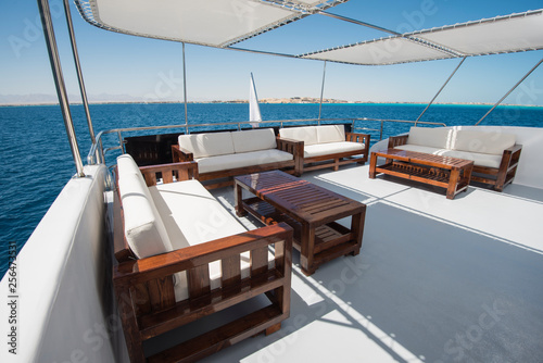 Table and chairs on deck of a luxury motor yacht © Paul Vinten