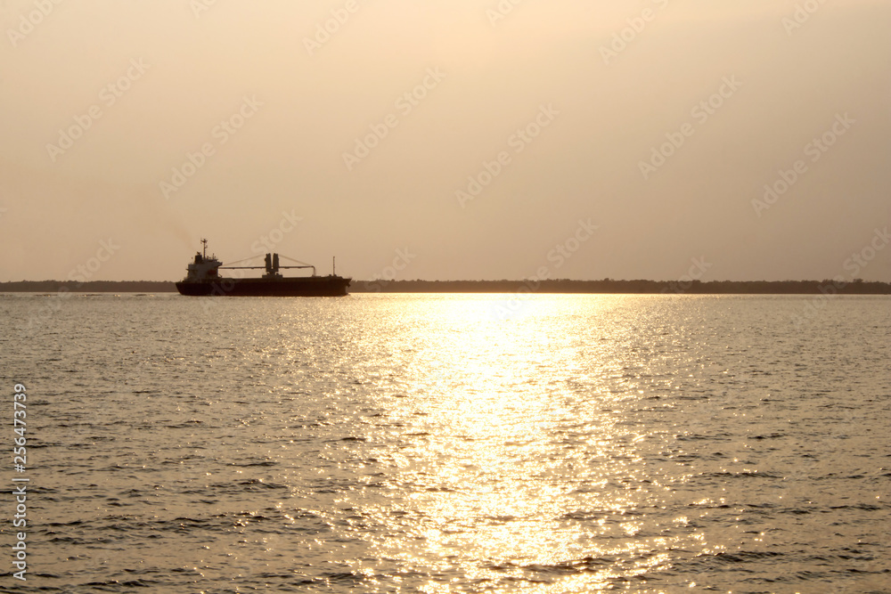 Transportation by ship At sunset with golden of The sun light.