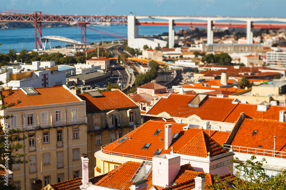 many bright tiled roofs of Lisbon, 25 th April Bridge connecting to of Almada