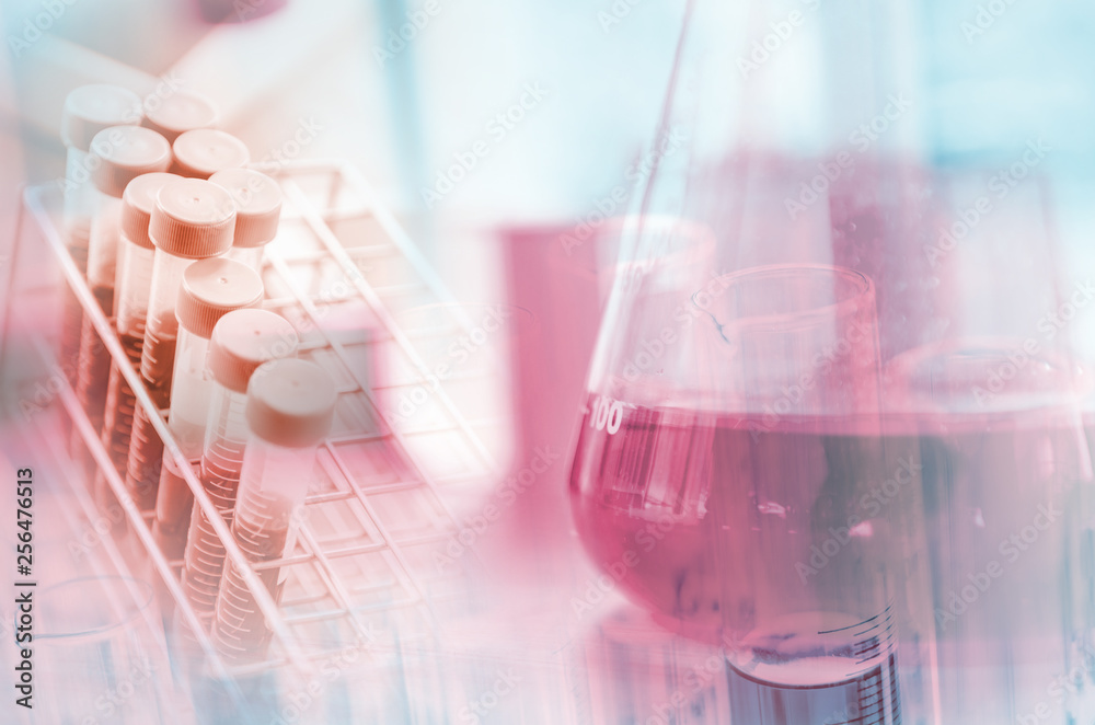 A pipette dropping sample into a test tube,abstract science background