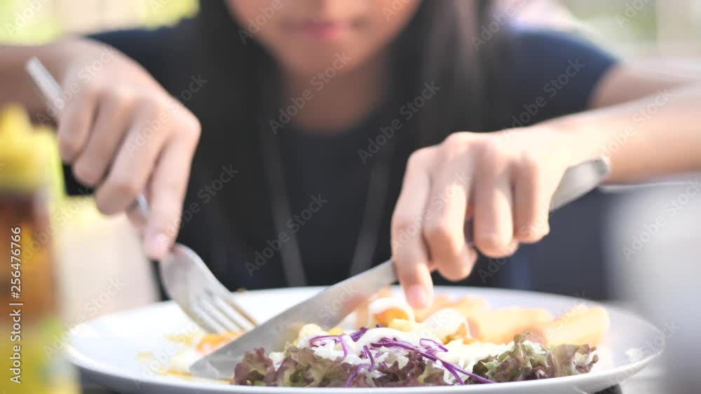 Happy Asian girl enjoy her breakfast outdoor, slow motion. Happy Asian girl enjoy her breakfast outdoor, slow motion.