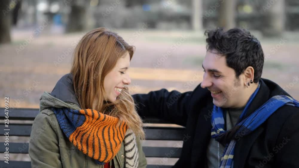 First date.smiling young couple flirting on park bench.Attraction,flirt First date.smiling young couple flirting on park bench.Attraction,flirt