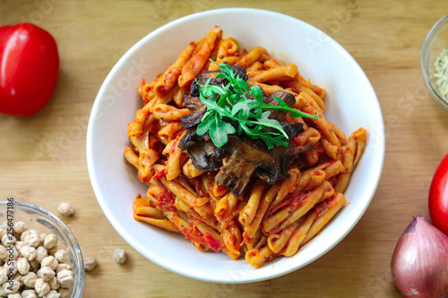 Vegan & Gluten free chickpea pasta with tomato sauce. topped with mushrooms and arugula. 