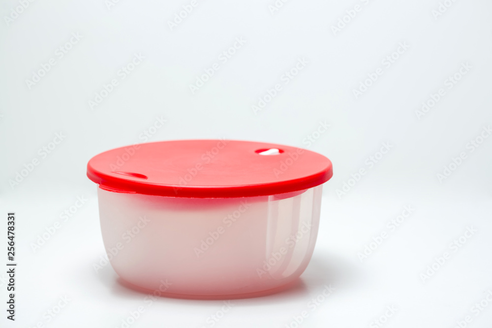Plastic container red for vegetables. White background. Plastic container red for vegetables. White background.