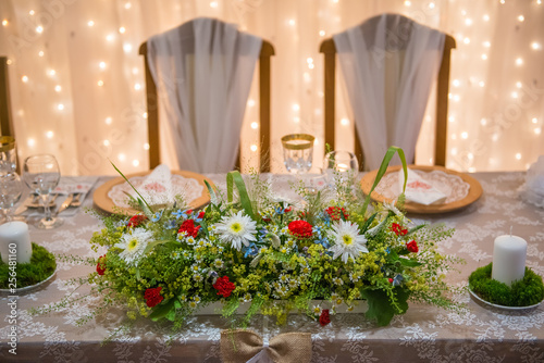 wedding table with floral arrangement prepared for reception  wedding  birthday or event centerpiece 