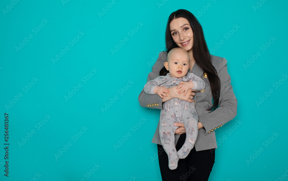 Young mother holding her newborn child. Woman and new born boy relax on color background. Mother breast feeding baby. Family at home. Young mother playing with her newborn son Young mother holding her newborn child. Woman and new born boy relax on color background. Mother breast feeding baby. Family at home. Young mother playing with her newborn son
