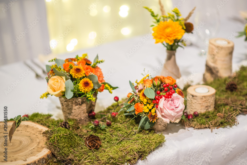 Fototapeta premium wedding table with floral arrangement prepared for reception, wedding, birthday or event centerpiece 