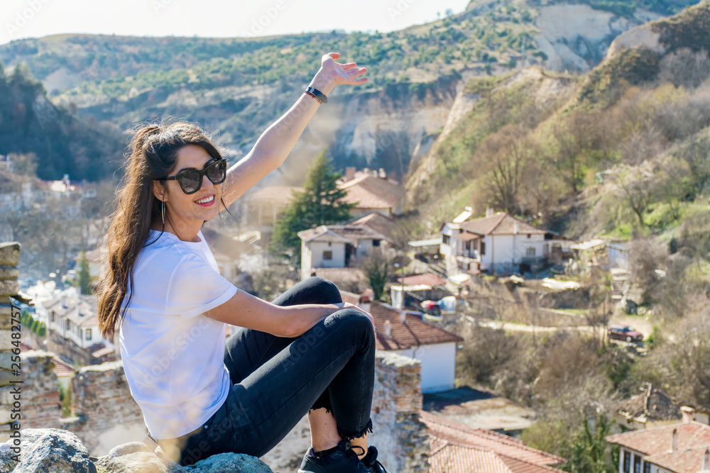 Beautiful Young Woman Sitting Above the City of Melnik in Bulgaria . Traveling Concept Beautiful Young Woman Sitting Above the City of Melnik in Bulgaria . Traveling Concept