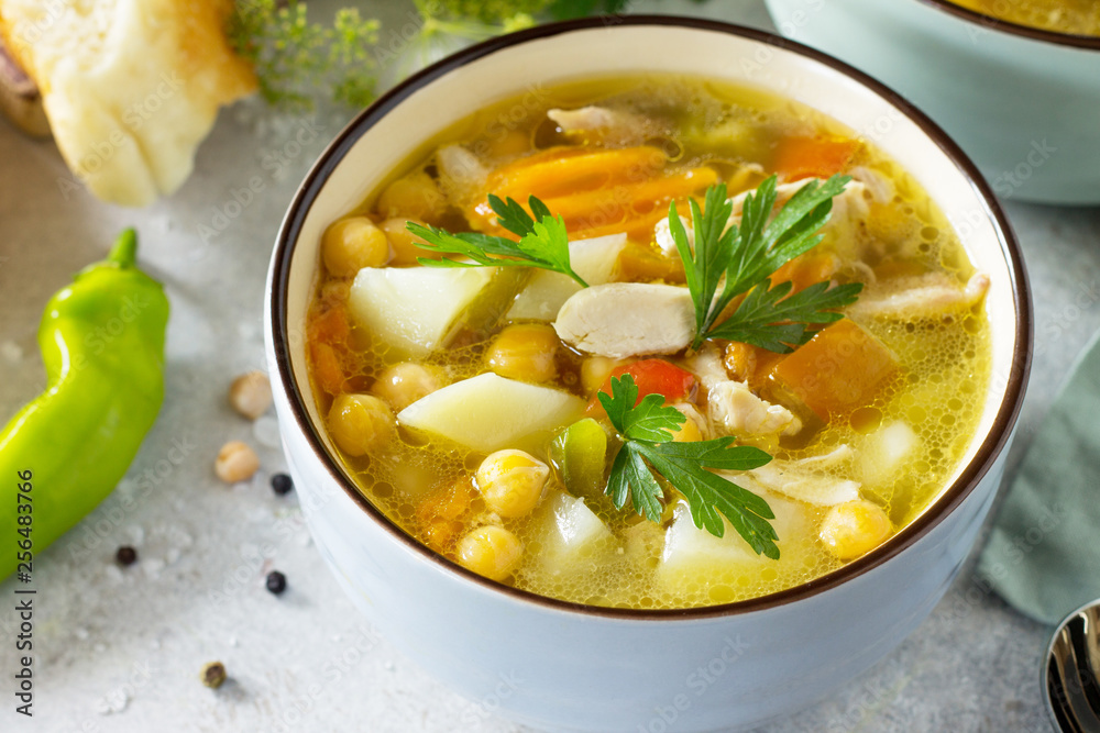 Homemade Hot Soup with Vegetables, Chicken and Peas Chickpeas. Eastern cuisine. The concept of healthy eating. Homemade Hot Soup with Vegetables, Chicken and Peas Chickpeas. Eastern cuisine. The concept of healthy eating.