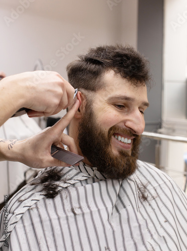 Young Man in Barbershop Hair Care Service Concept 