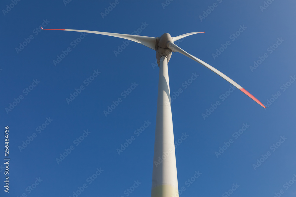 wind turbine with sun flare blue sky background view from below wind turbine with sun flare blue sky background view from below
