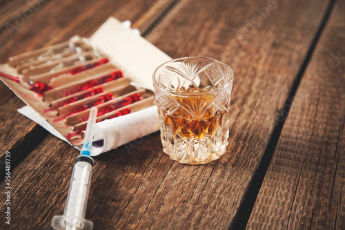 drug with syringe and whiskey