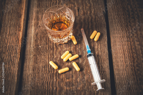 drug with syringe and whiskey