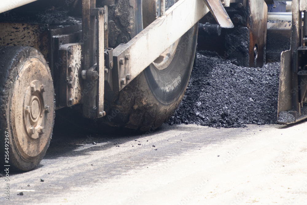 Fototapeta premium Road construction asphalt road by worker and roller machine. Asphalt road background