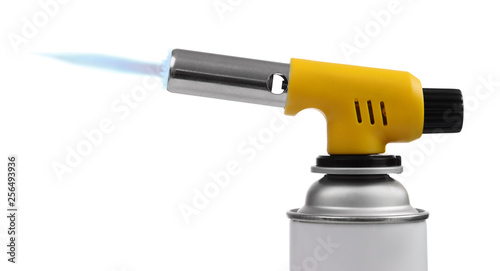 Manual gas torch burner (blowtorch) on spray can with blue flame for camping, soldering or repair isolated on white background. Serie of tools. photo