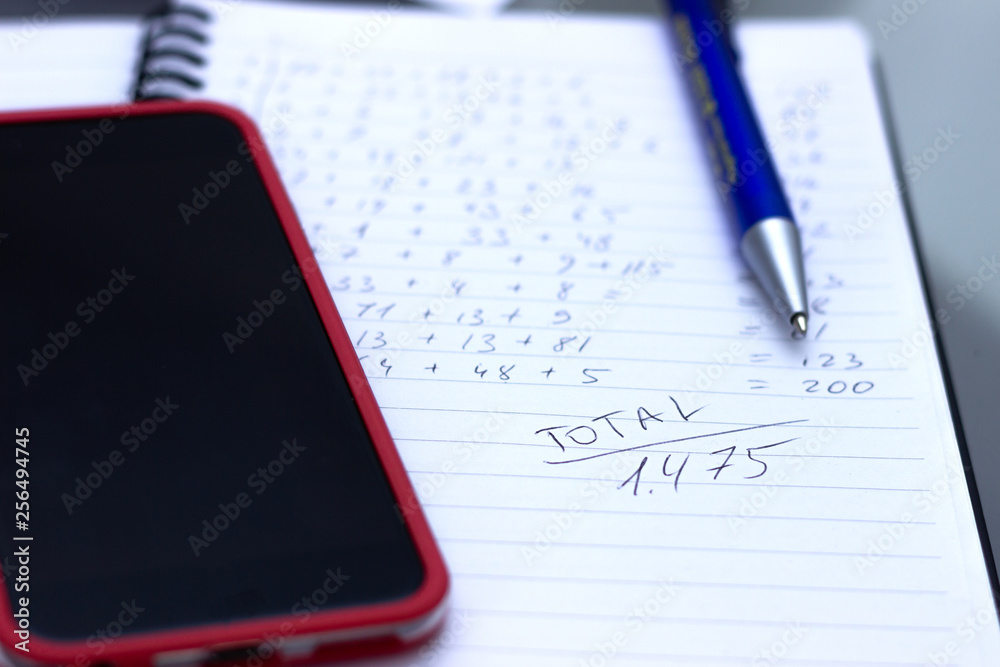 Phone calculator, notebook with calculations written by hand. Phone calculator, notebook with calculations written by hand.