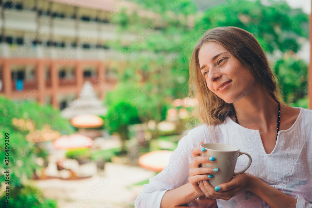 beautiful girl with long hair and blue manicure holding a large mug beautiful girl with long hair and blue manicure holding a large mug