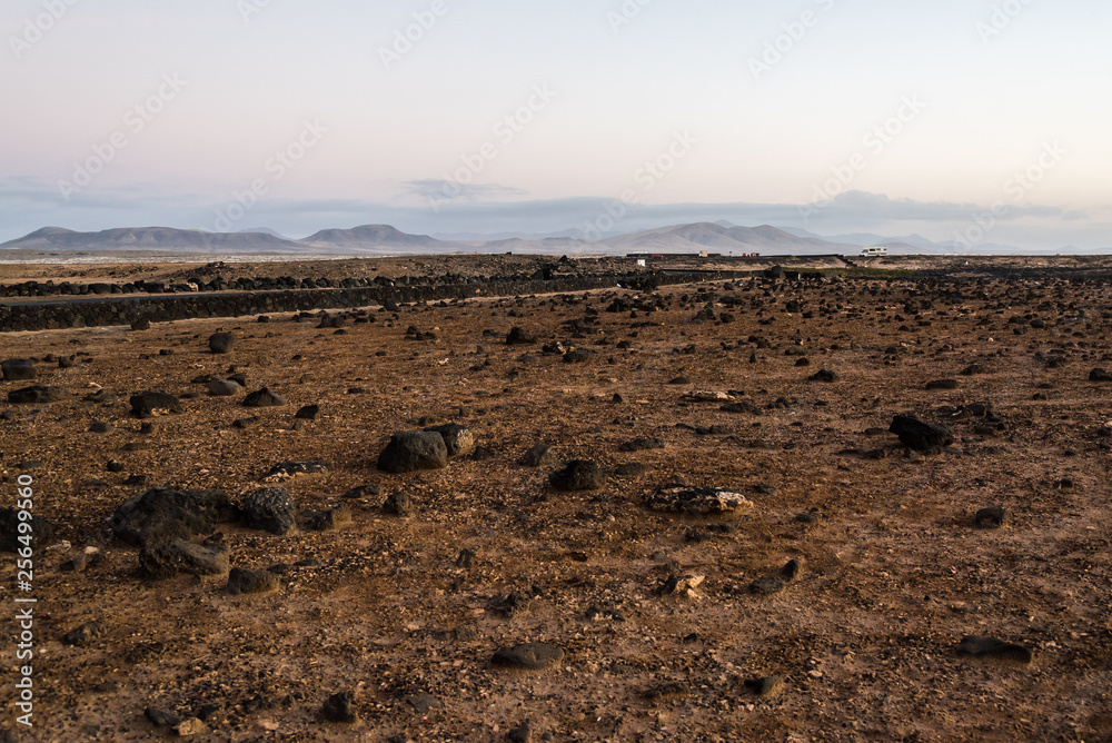 Obraz premium Scenic view of volcanic landscape at sunset