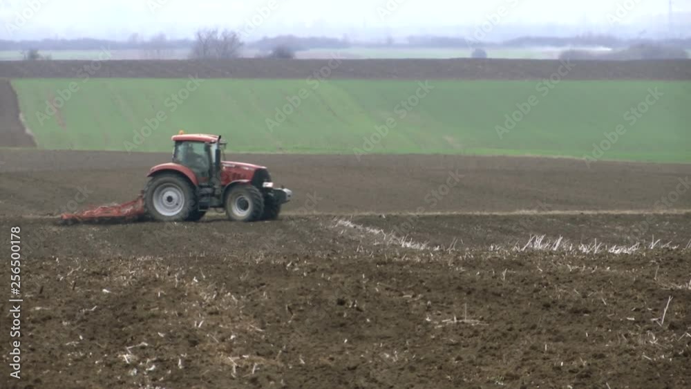 a tractor in the field turns and prepares to work in the field a tractor in the field turns and prepares to work in the field
