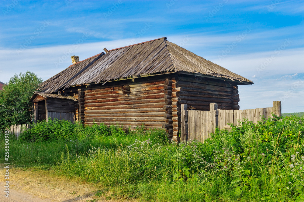 old wooden house in the village on a summer day old wooden house in the village on a summer day