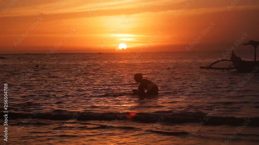 beautiful sunset on tropical beach by the sea in Bali beautiful sunset on tropical beach by the sea in Bali