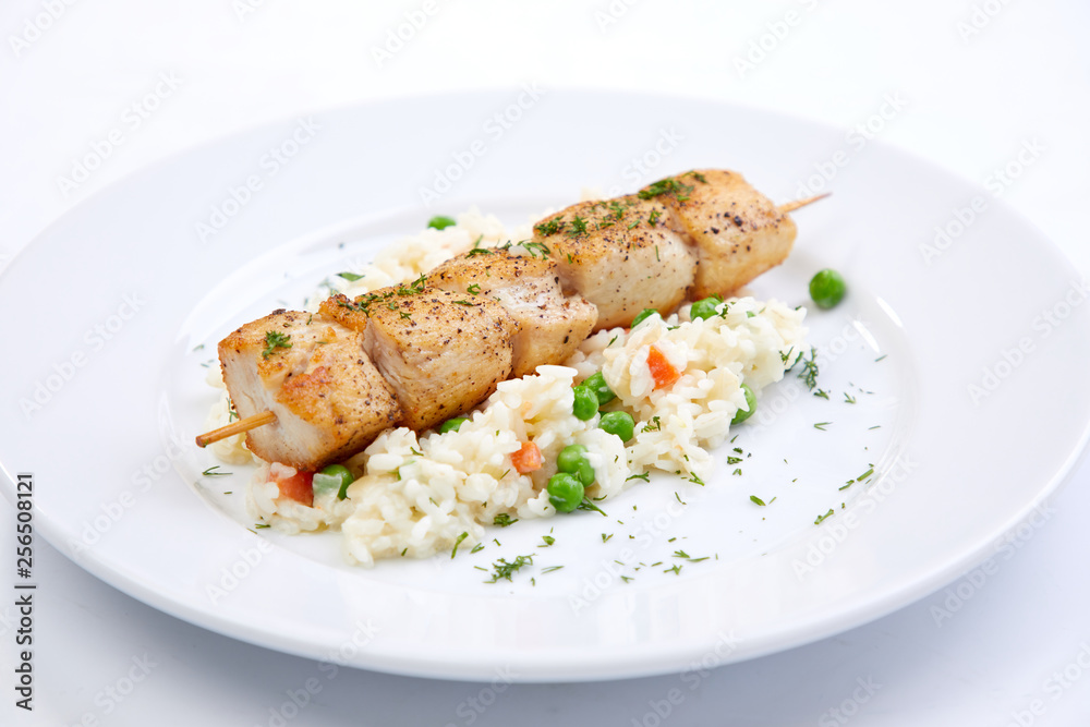 chicken kebab with rice and vegetables on the white background