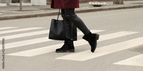 close up of woman legs walking on crosswalk