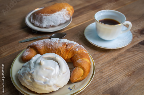 Sweet donut and bagel on a plate on wooden table
