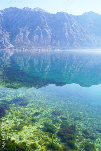 Picturesque mountain range and its reflection in clear water. © tanyatorgonskaya