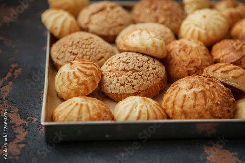 Homemade profiteroles on the music sheet with notes. Profiteroles (choux à la crème) - French choux pastry balls filled with custard or cottage cheese