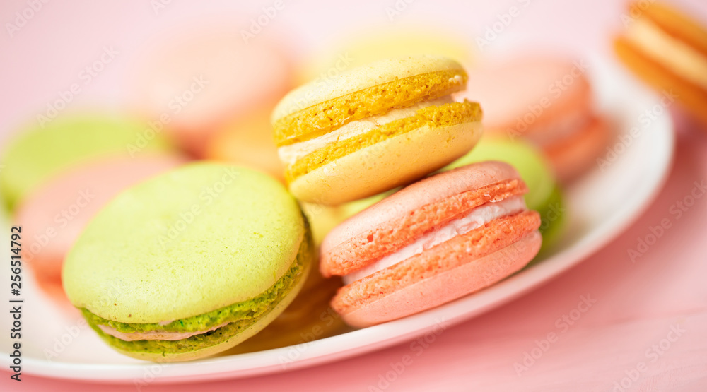 Dessert cake macaron or macaroon on pink background top view. Flat lay composition. Dessert cake macaron or macaroon on pink background top view. Flat lay composition.