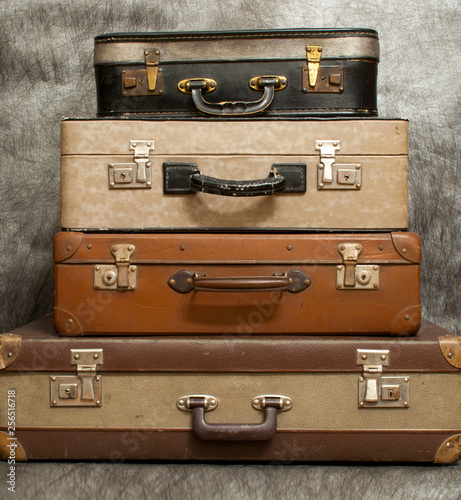 old and damaged suitcases stacked on top of each other