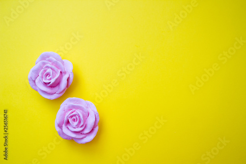 Polymer clay flowers  bright yellow background. Copy space