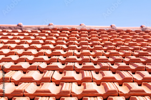 Roofing construction. Roof ceramic tiles on blue sky background