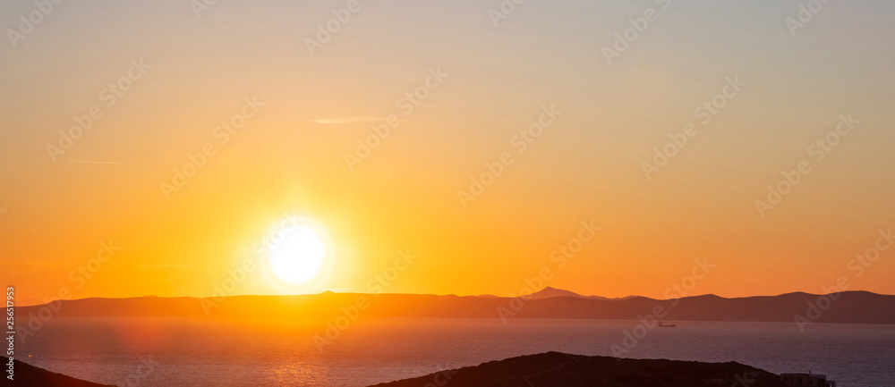 Fototapeta premium Sunset over Attica, clear orange color sky background, Kea island, Greece.