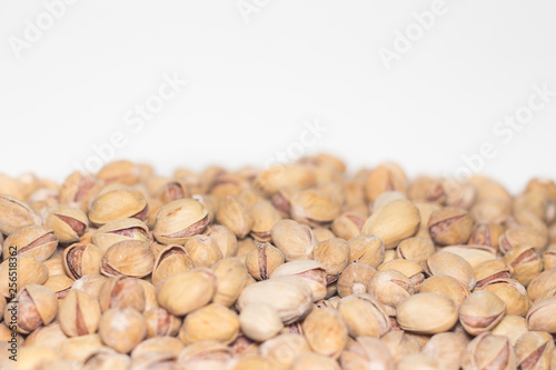 Roasted and salted pistachios in shell. Partial focus. Food background.