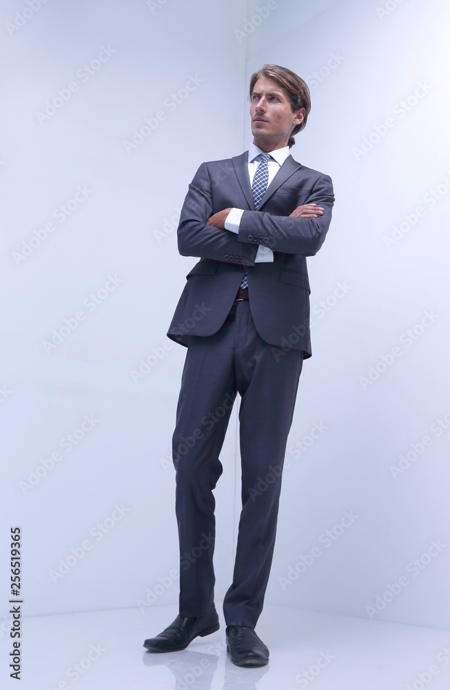serious businessman standing in a blank room. serious businessman standing in a blank room.