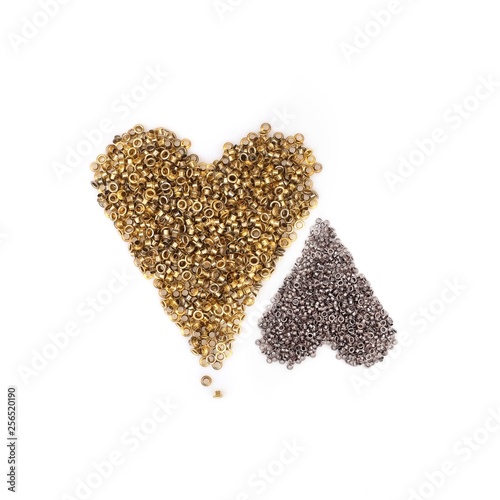 Spilled gold grommets isolated on white background