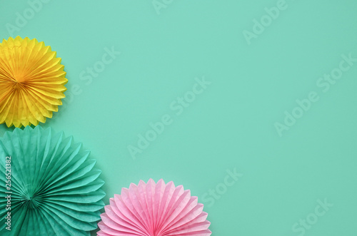 Paper texture flowers  on green background. Birthday  holiday or party background. Flat lay style.