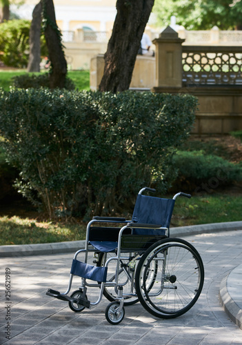 Empty wheelchair at the park, close-up, outdoors. Miracle concept © Gecko Studio