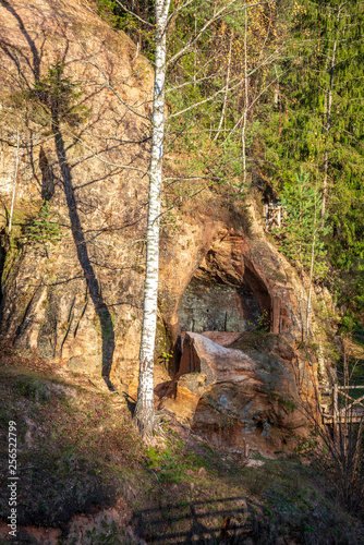 sandstone cliffs with natural caves © Martins Vanags