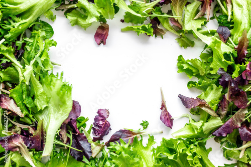 fitness food cooking with green and red salad mix on white background top view copyspace