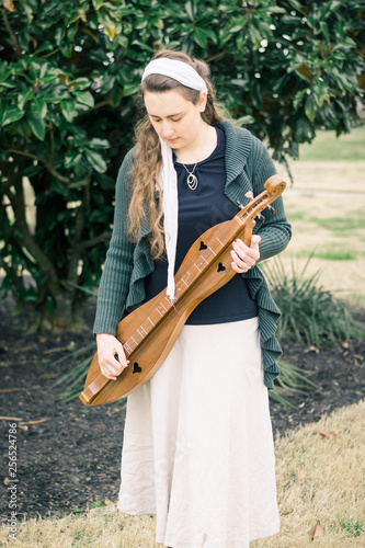 Girl Standing Outdoors Holding an Hour-Glass Mountain Dulcimer