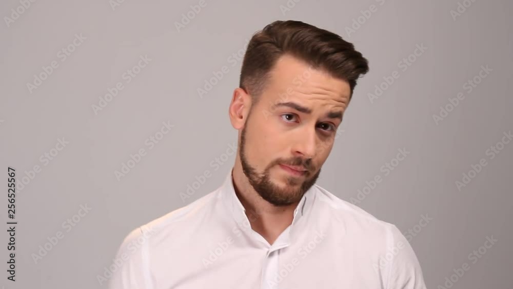 Portrait of angry man gesturing with his finger against his temple, are you crazy Portrait of angry man gesturing with his finger against his temple, are you crazy