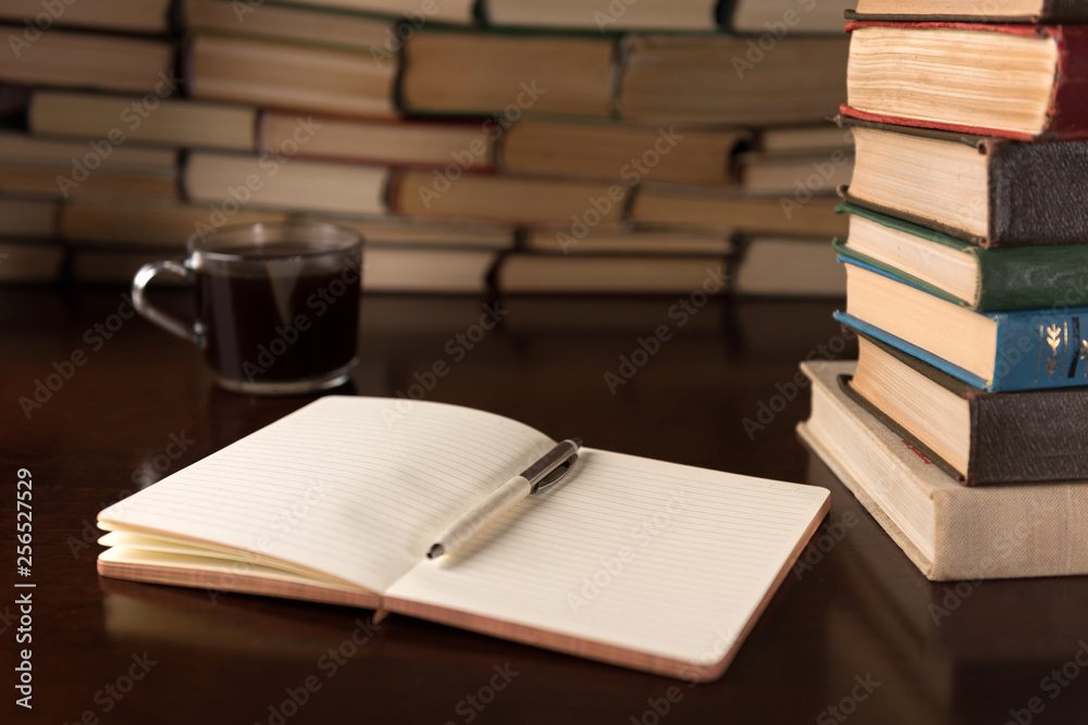 Naklejka premium open notebook and cup on the desktop