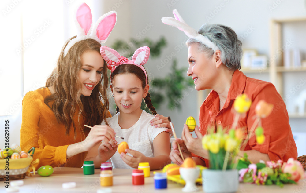 happy Easter! family grandmother, mother and child paint eggs and prepare for holiday. happy Easter! family grandmother, mother and child paint eggs and prepare for holiday.