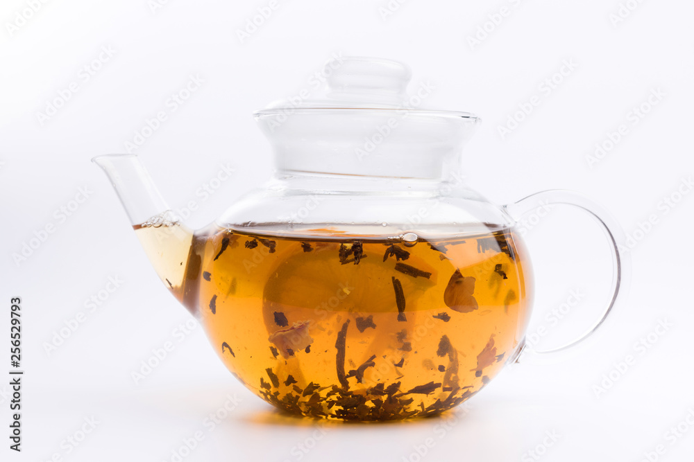 Glass teapot with black tea nad fresh orange isolated on white background Glass teapot with black tea nad fresh orange isolated on white background