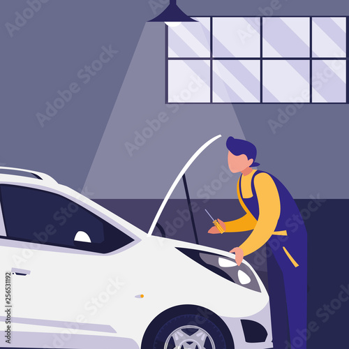 mechanic worker with car in the workshop