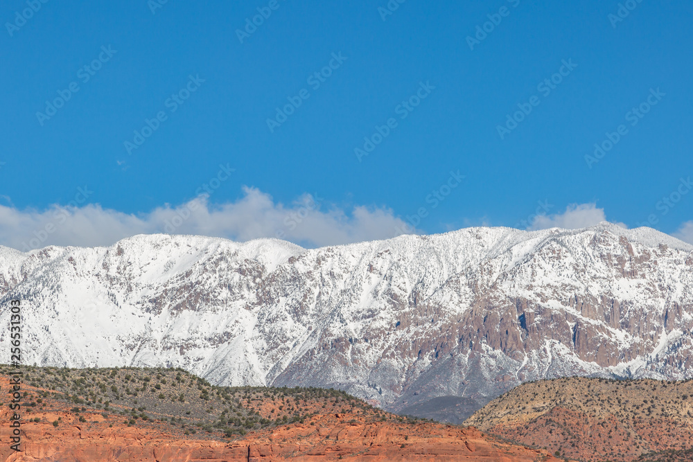 Snow covered Mountains beneath a blue sky, in Utah