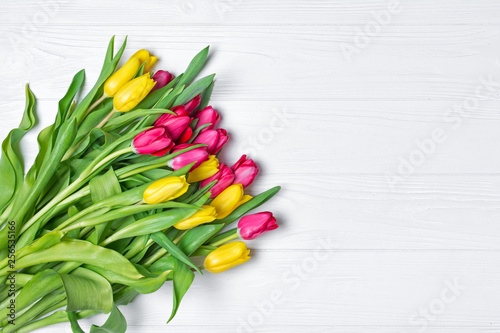 Beautiful fresh yellow and pink tulips bouquet on white